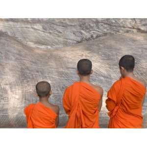 Three Young Monks Praying at a Rock Cut Image of the Buddha in the Gal 
